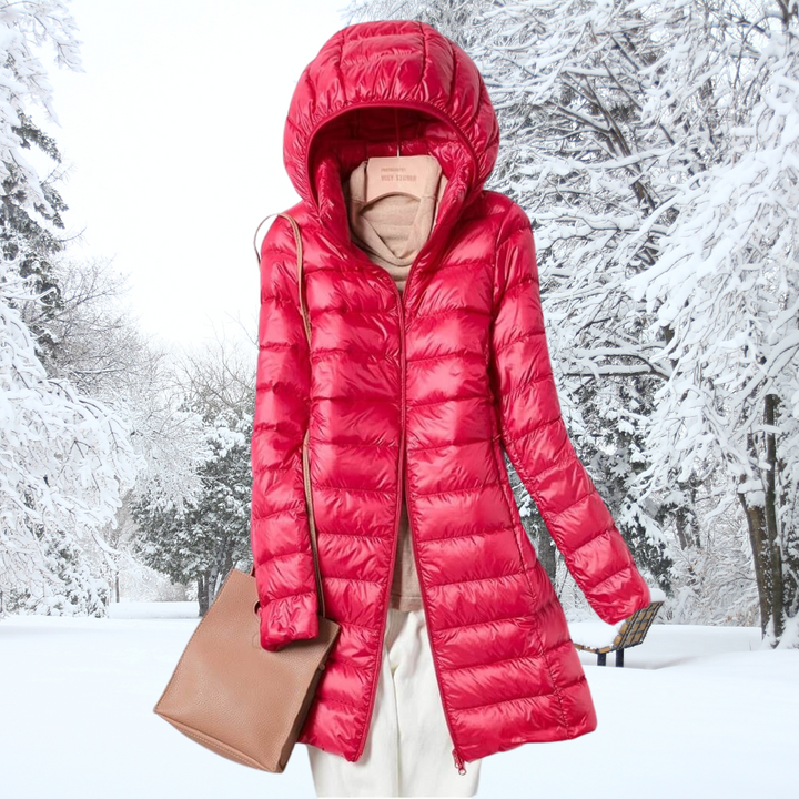 Lightweight women's travel jacket, insulated with hood, designed for easy packing and comfort.