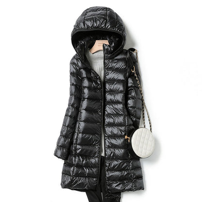 Women's insulated hooded jacket, lightweight & cozy. Perfect for travel, fall, and winter outdoor adventures.
