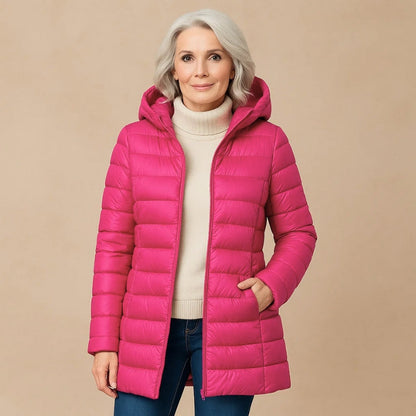 Lightweight women's insulated jacket with hood. Stylish & warm outerwear for fall, winter, and outdoor travel.