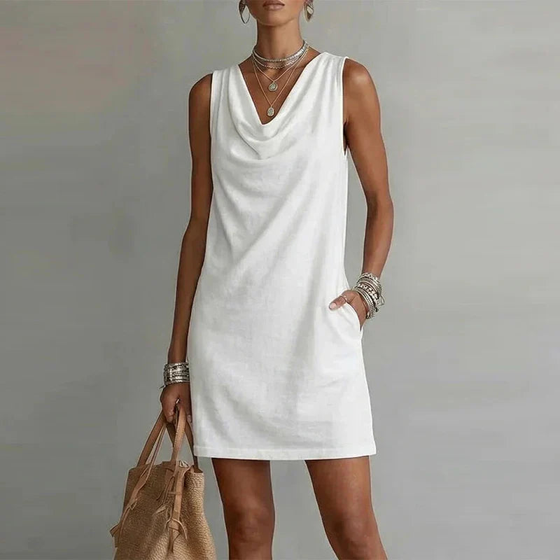 Women's relaxed fit mini dress, lightweight, sleeveless, featuring a flattering draped neckline & useful pockets.