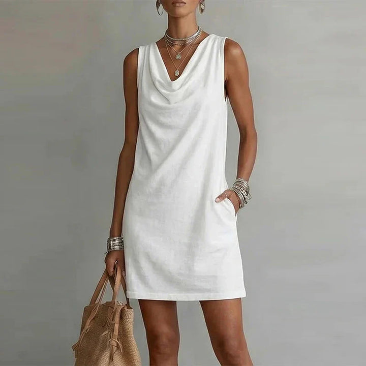 Women's relaxed fit mini dress, lightweight, sleeveless, featuring a flattering draped neckline & useful pockets.