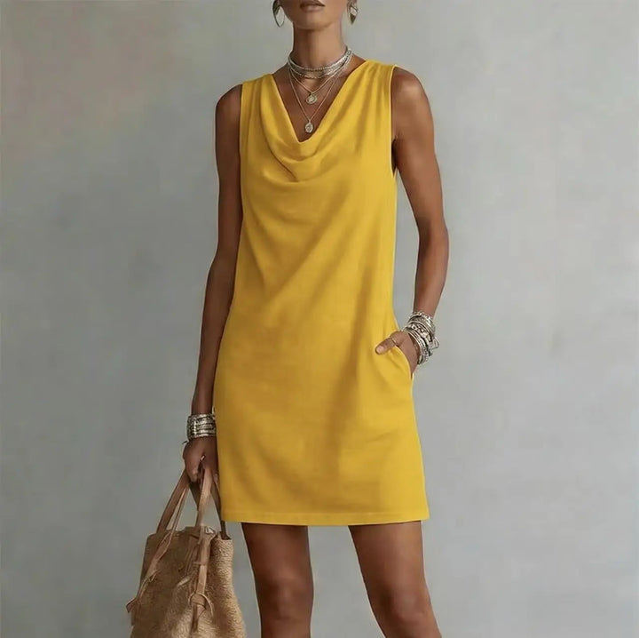 Vacation-ready women's mini dress with a relaxed fit, sleeveless design, draped neckline & convenient pockets.