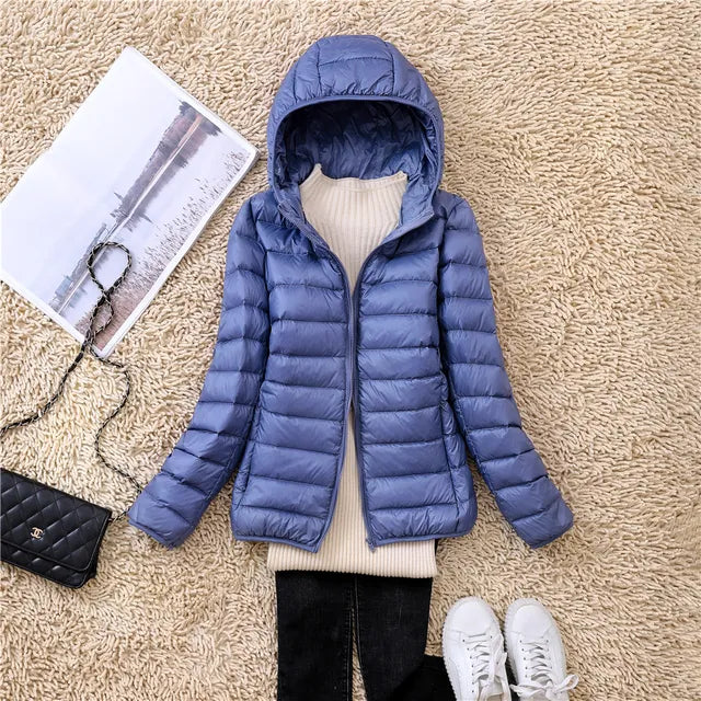 Soft-touch women's lightweight packable hooded jacket, insulated for comfort.