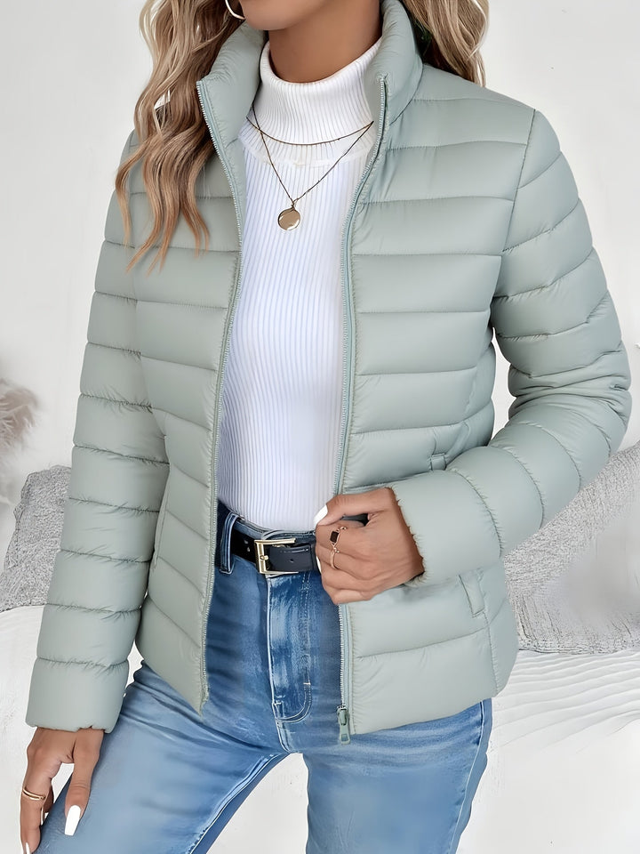 Women's lightweight quilted jacket with stand collar & zip closure. Perfect casual outerwear for fall & winter.