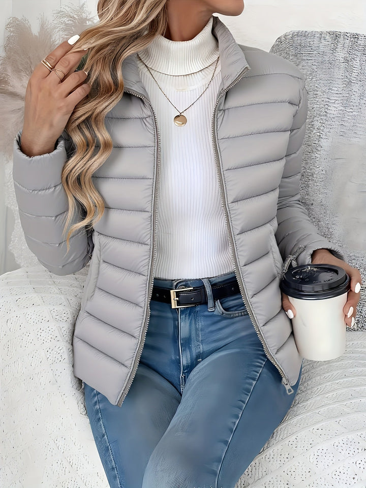 Casual women's fall jacket, quilted & lightweight. Features a stand collar & full zip. Great for everyday wear.