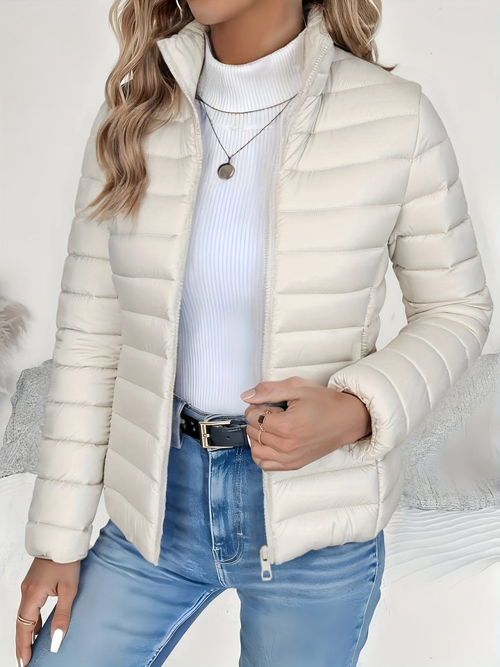 Women's long-sleeve quilted jacket with stand collar & sturdy zip closure. Lightweight casual outerwear for women.