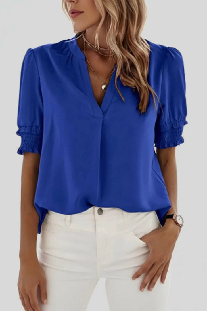 Stylish V-neck women's blouse with delicate puff sleeves. This lightweight top offers an elegant, flattering fit.