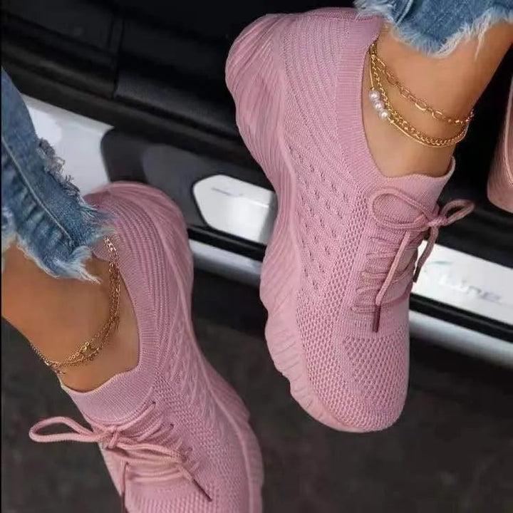 Side view of women's lightweight walking sneakers, showcasing cushioned sole and breathable material.