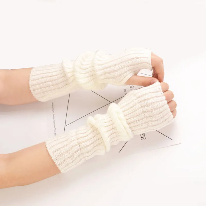 Cozy long fingerless knitted cotton gloves for women, ideal for winter warmth and flexibility.
