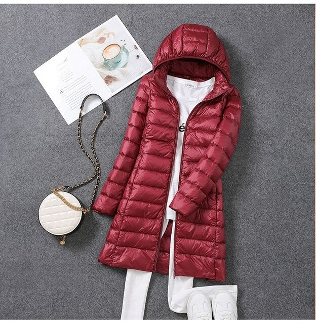 Women's long hooded puffer coat, cozy winter outerwear for cold weather fashion.