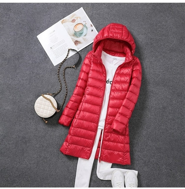 Stylish women's long puffer jacket with hood, perfect for winter fashion & warmth.