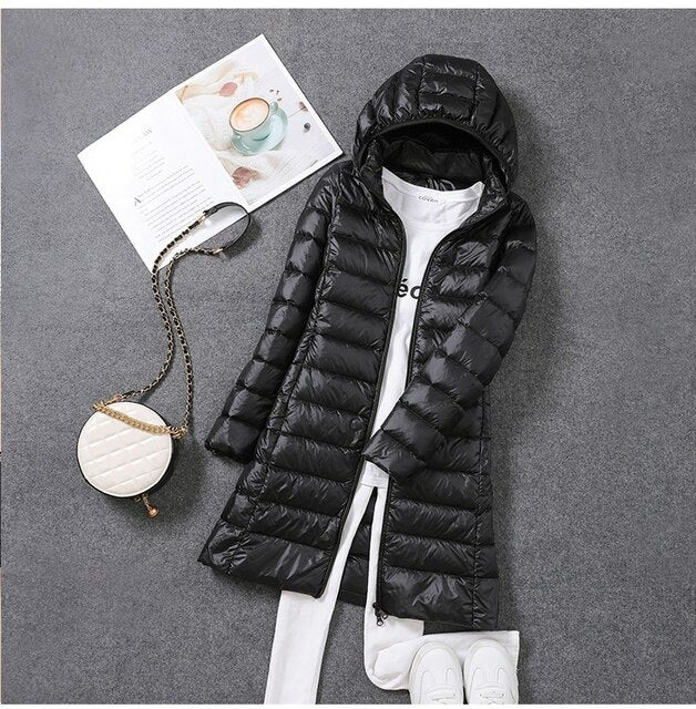 Cozy women's hooded long puffer coat, ideal winter outerwear for cold weather.