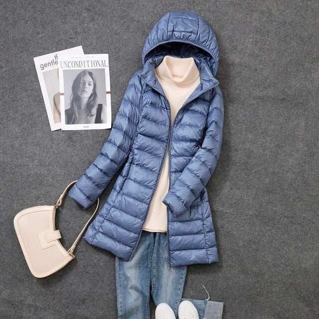 Warm & cozy women's long puffer coat, a hooded winter jacket for ultimate cold weather comfort.