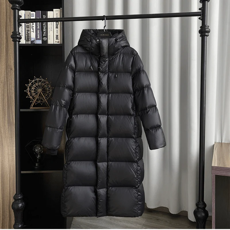 Warm women's full-length quilted winter jacket with hood. Padded maxi coat for ultimate cold weather comfort.