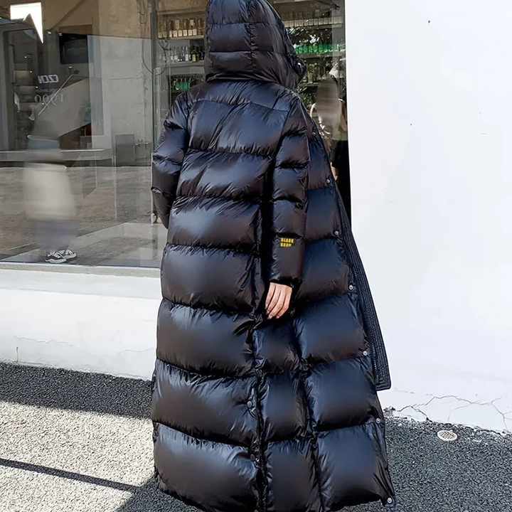 Women's fashionable quilted hooded winter jacket. Long, padded maxi coat, ideal for cold weather outerwear.