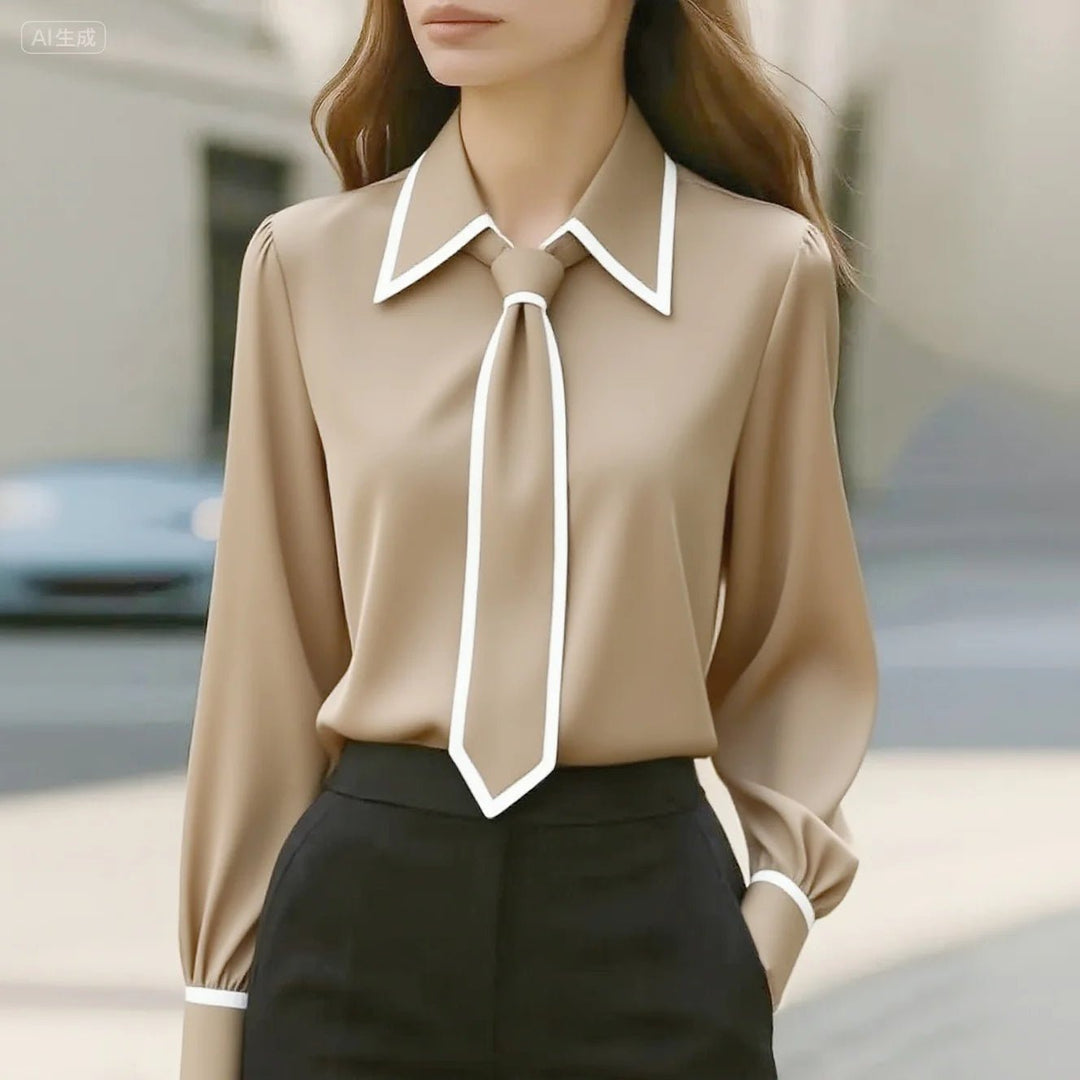 Elegant women's professional long sleeve blouse with tie neck and stylish contrast trim detail. Versatile workwear.