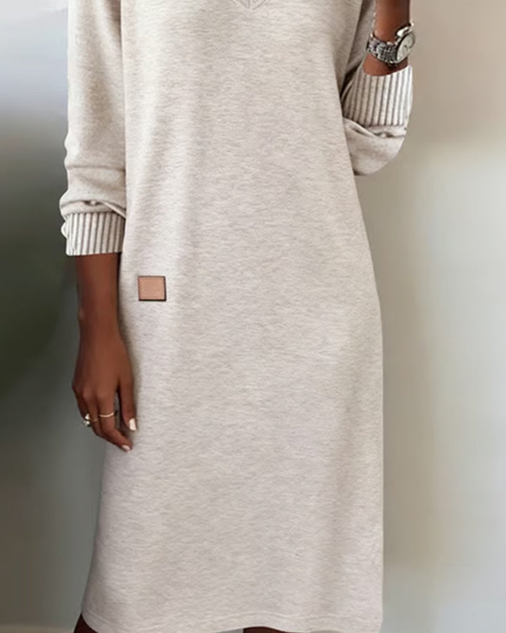 Versatile women's V-neck long sleeve midi dress. Ideal for office sophistication or relaxed casual style.
