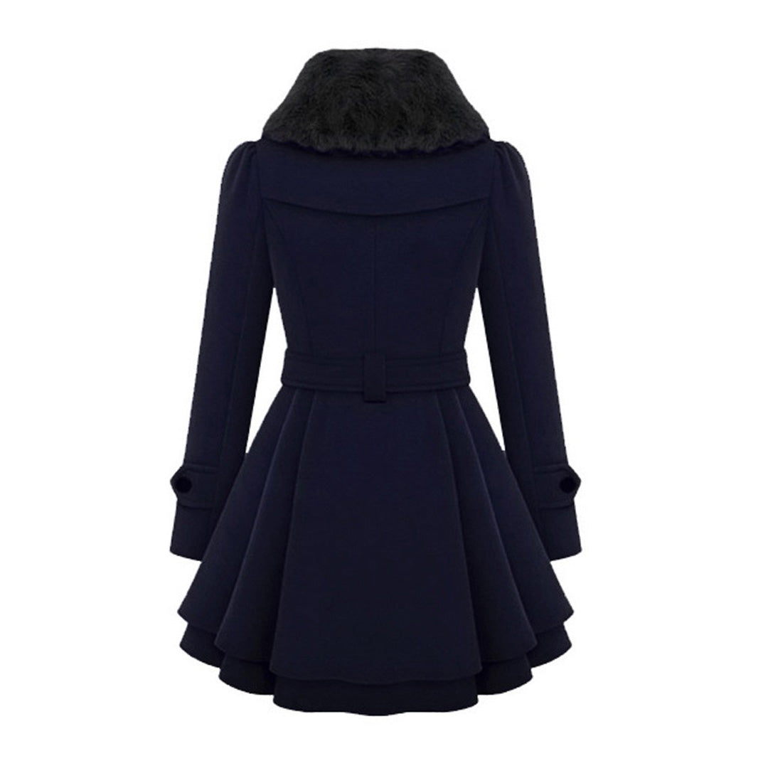 Woman wearing a long tailored coat with a soft collar, styled for elegant everyday autumn fashion.