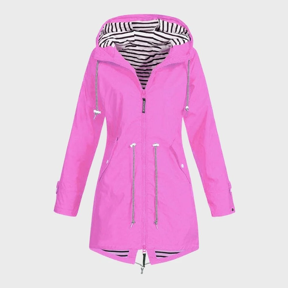 Woman wearing a long waterproof hooded rain jacket, walking outdoors. Perfect for all-season protection.