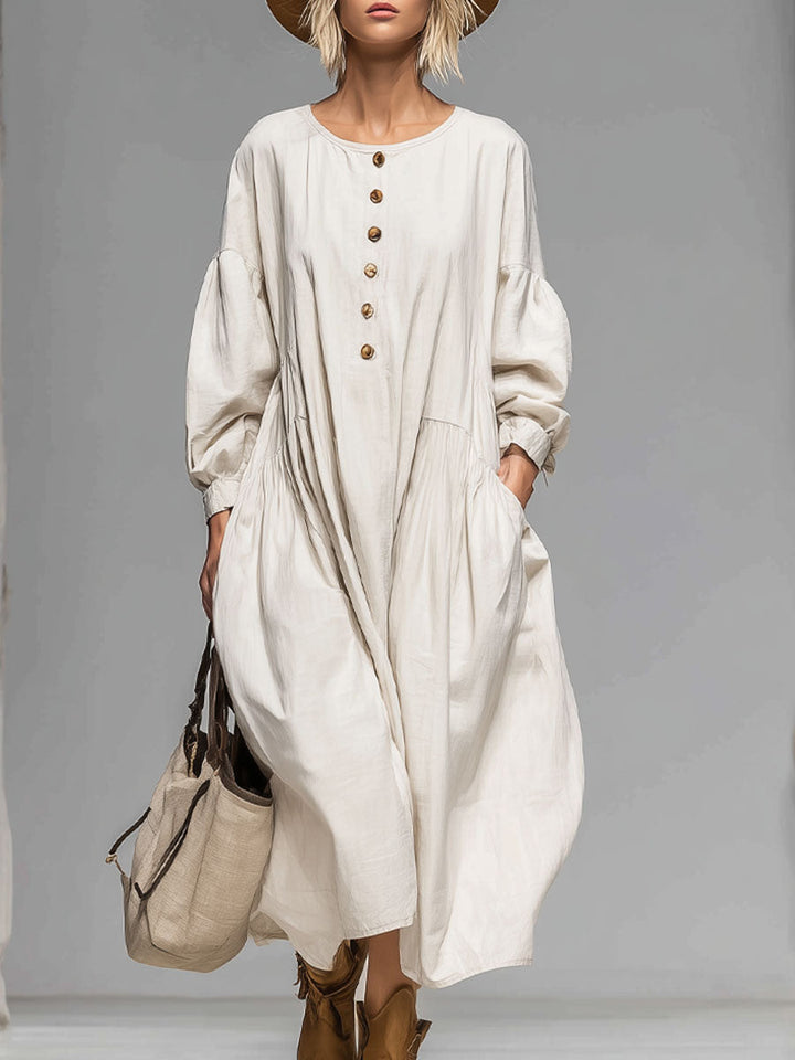 Women's loose fit long-sleeved midi dress with a round neck and pockets, perfect for comfortable everyday casual wear.
