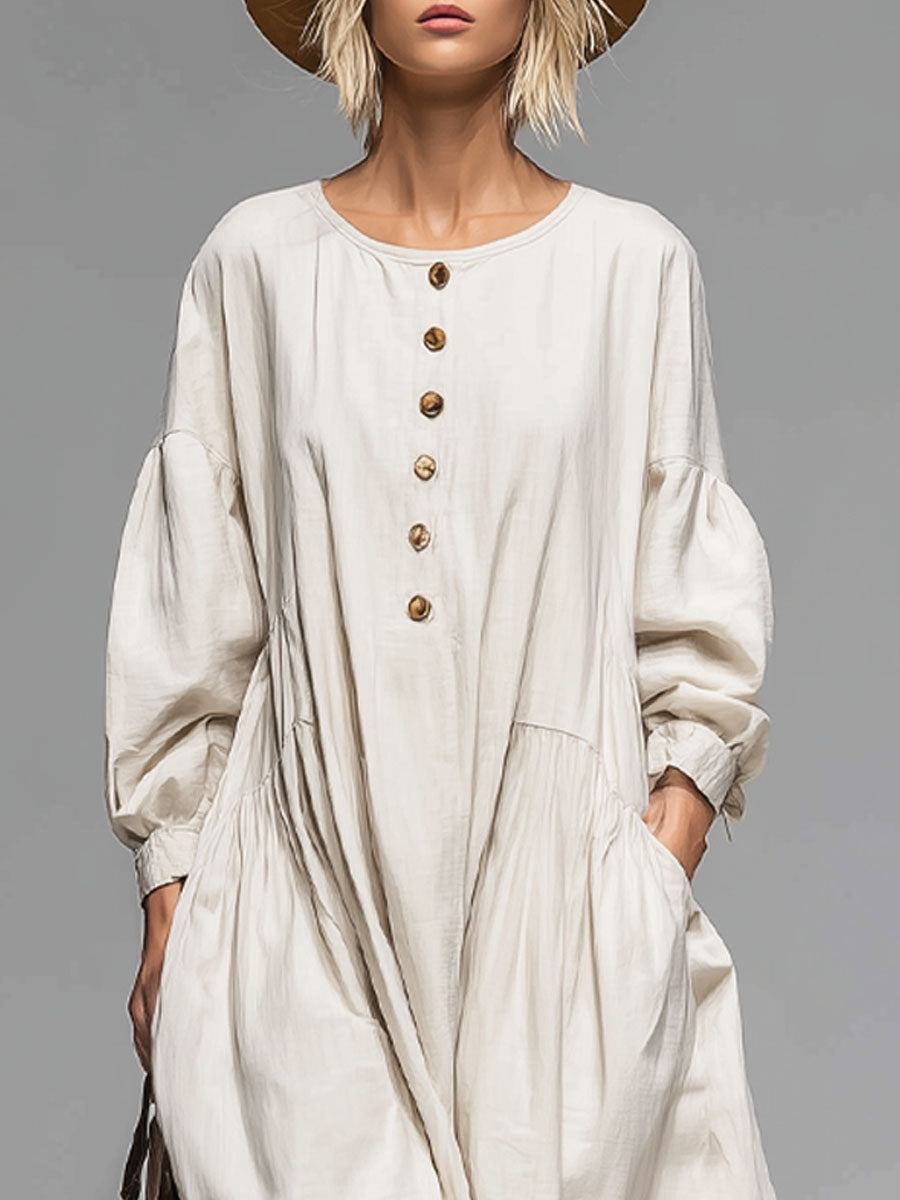 Casual women's long-sleeved midi dress featuring a button front, loose fit, and practical pockets. Versatile day dress.