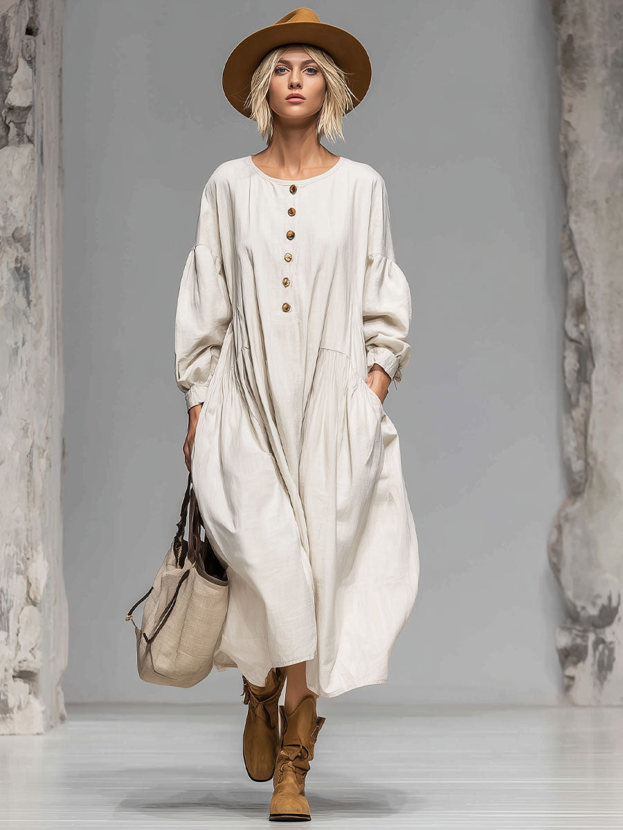 Comfortable women's loose fit long-sleeved midi dress with a flowing silhouette, round neck, and convenient pockets.