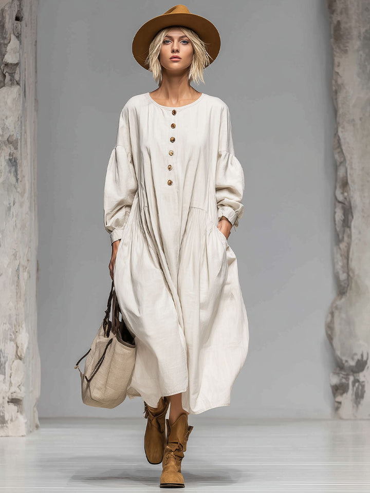 Comfortable women's loose fit long-sleeved midi dress with a flowing silhouette, round neck, and convenient pockets.