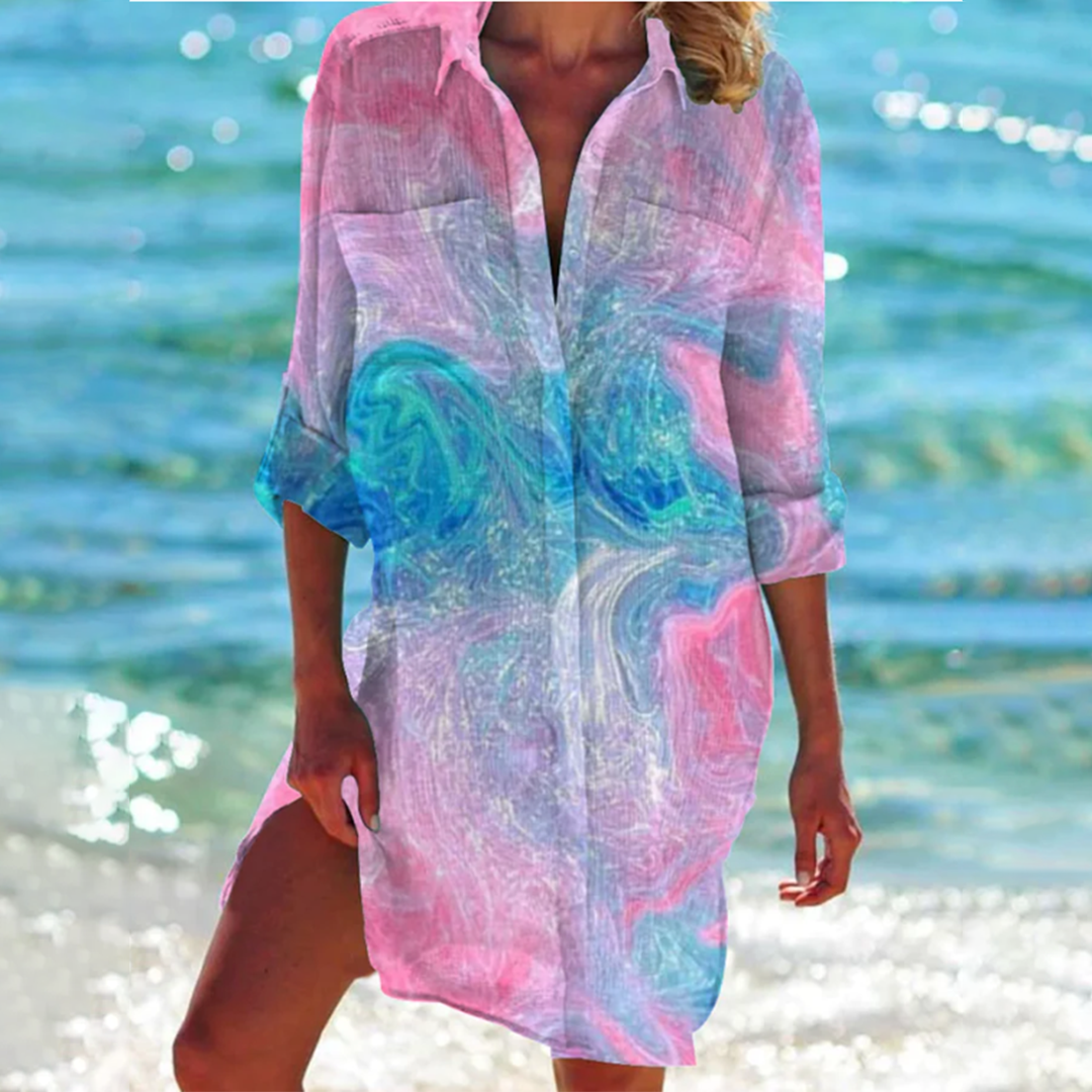 Vibrant printed loose fit women's summer shirt with convenient pockets. Short sleeve, A-line cut for casual style.