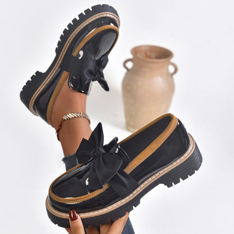 Woman wearing comfortable Lucente black patent bowknot loafers, ideal for everyday casual & dressy styling.