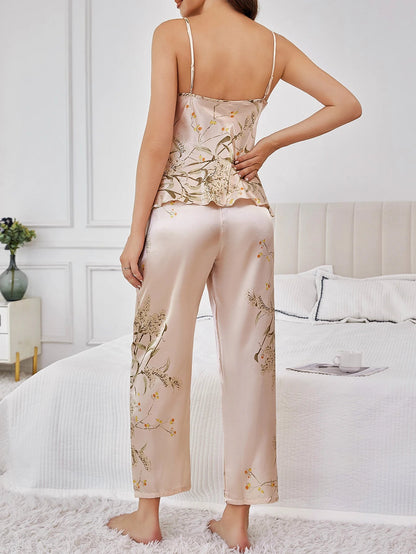 Smiling woman showcasing luxurious satin floral lounge set. Comfortable two-piece sleepwear pajamas.