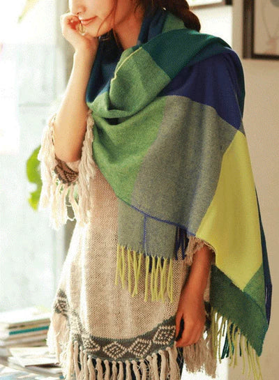 Close-up of a plush women's luxury cashmere check pattern scarf, showing its soft texture.