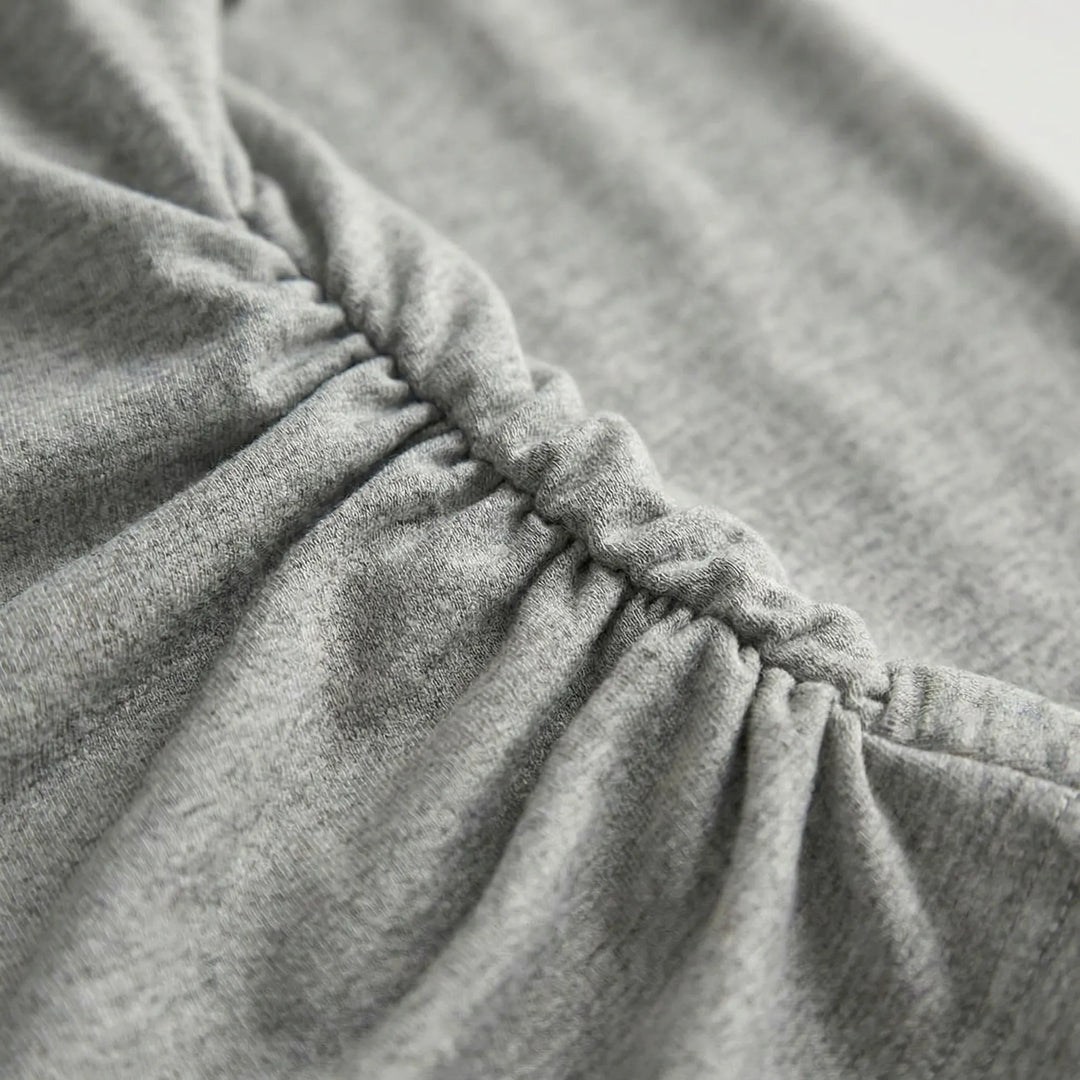 Pullover women's long-sleeve pleated top, featuring flattering ruched details. Ideal as a layering piece or casual wear.