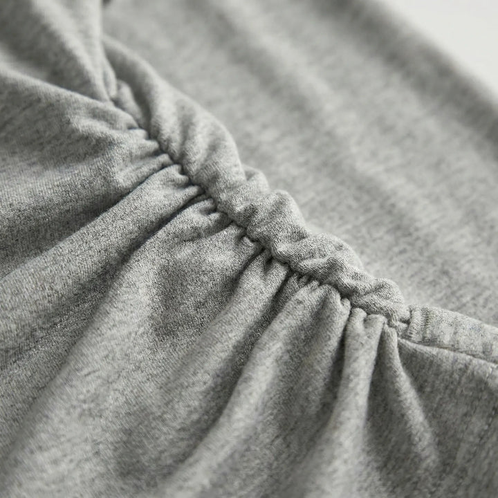 Pullover women's long-sleeve pleated top, featuring flattering ruched details. Ideal as a layering piece or casual wear.