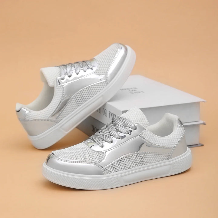 Comfortable women's metallic mesh lace-up sneakers for walking. Stylish athletic footwear for casual outings.