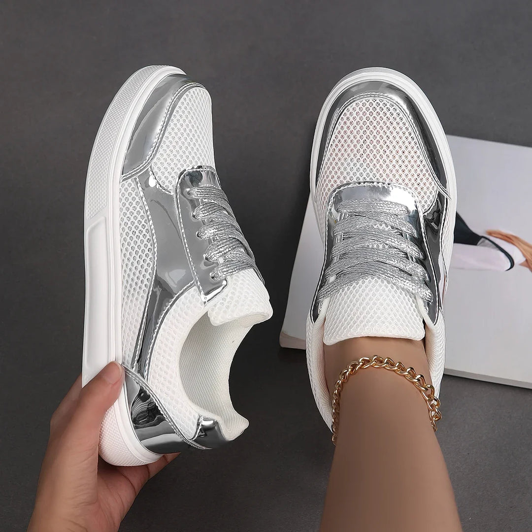 Athletic women's metallic mesh lace-up sneakers. Modern design, comfortable & breathable for active lifestyles.