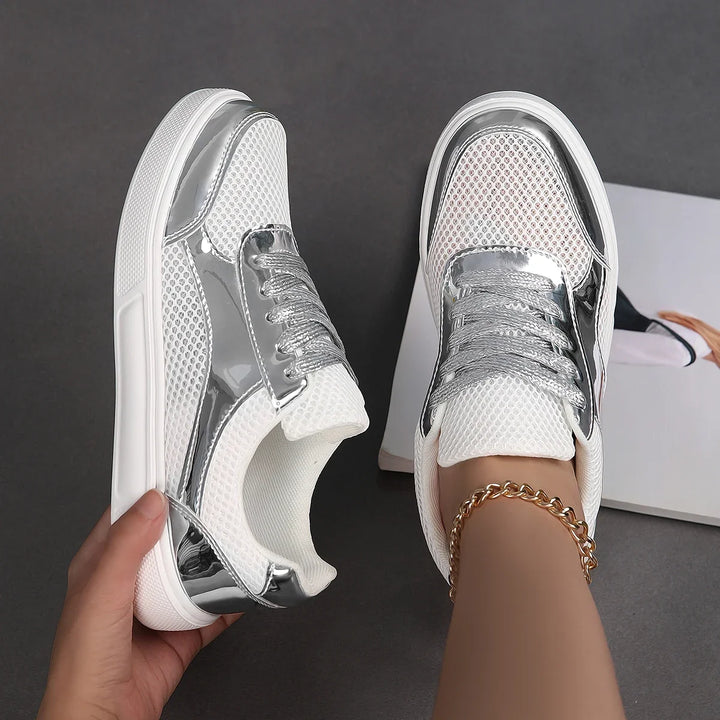 Athletic women's metallic mesh lace-up sneakers. Modern design, comfortable & breathable for active lifestyles.