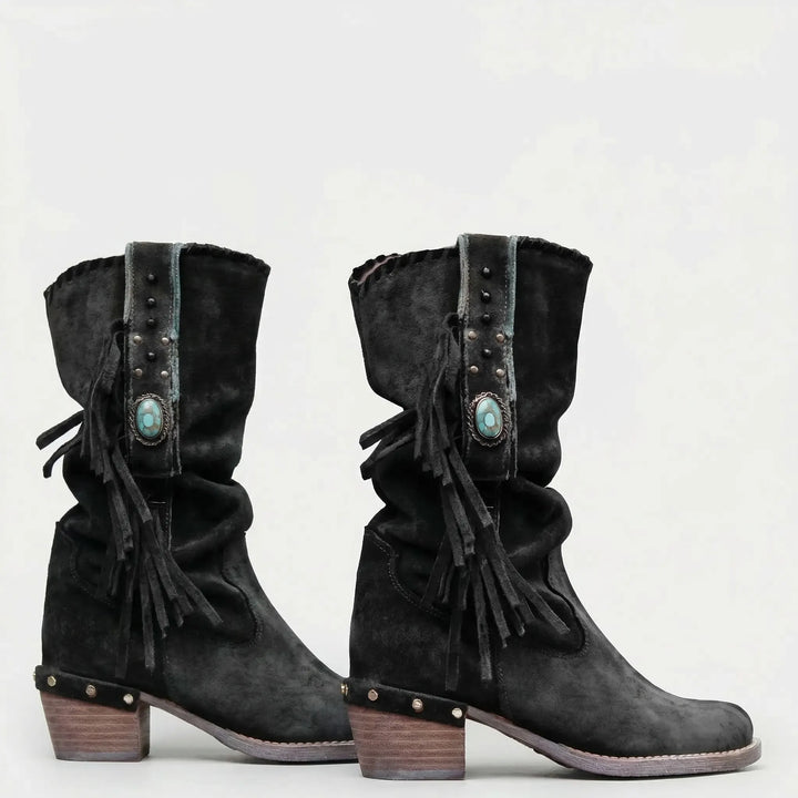 Fashionable women's mid-calf western boots with boho fringe, a comfortable block heel, and pointed toe.