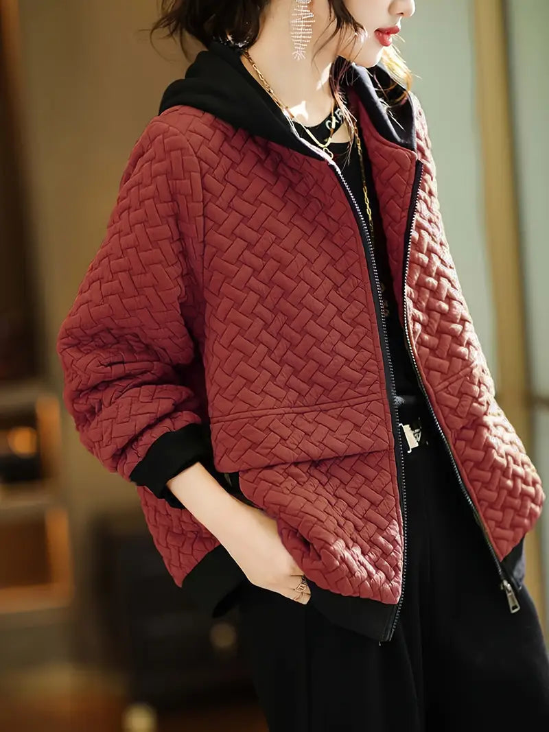 Stylish women's quilted jacket in a basketweave pattern with a hood, designed for modern layering.