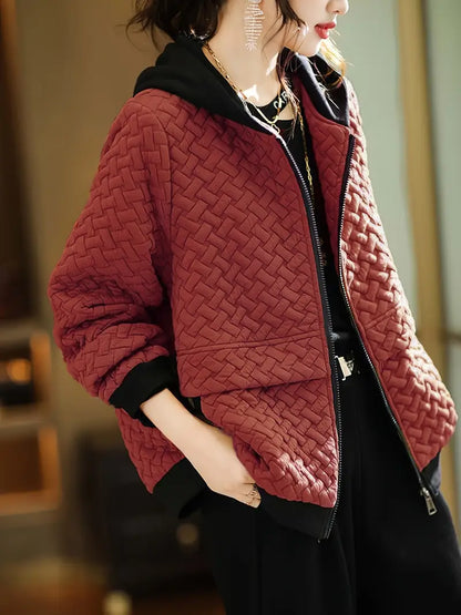 Stylish women's quilted jacket in a basketweave pattern with a hood, designed for modern layering.