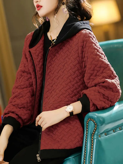 Woman wearing a stylish Mirelle quilted hoodie jacket, perfect for everyday casual outerwear.