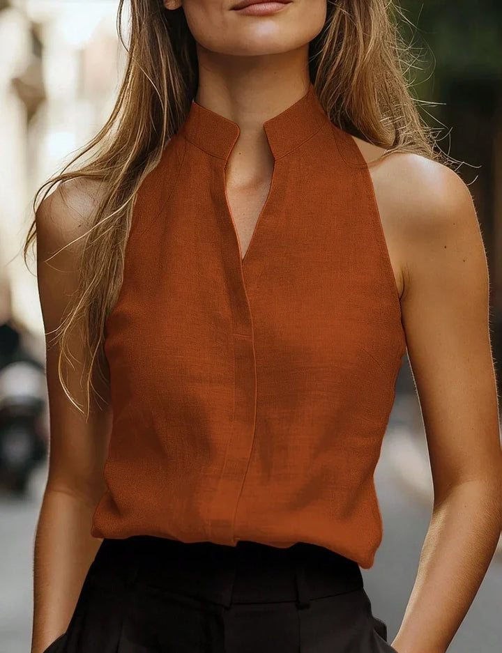 Women's mock neck sleeveless blouse, perfect for elegant summer style or versatile casual wear. Relaxed fit top.
