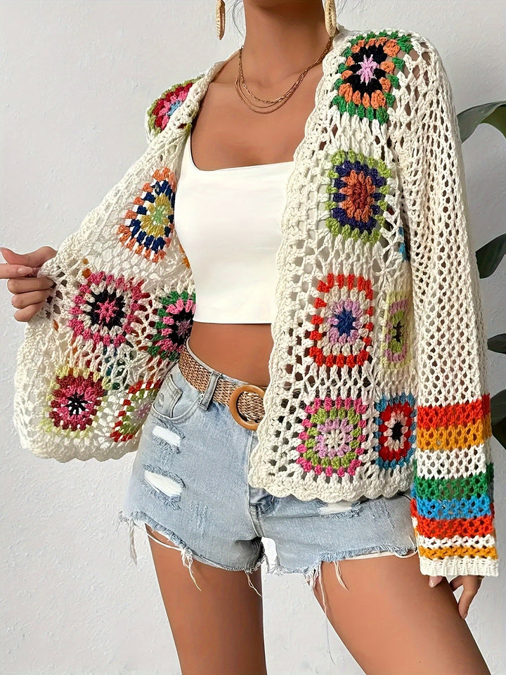 Women's artistic mosaic crochet cardigan with elegant flared sleeves. A vibrant outerwear piece.