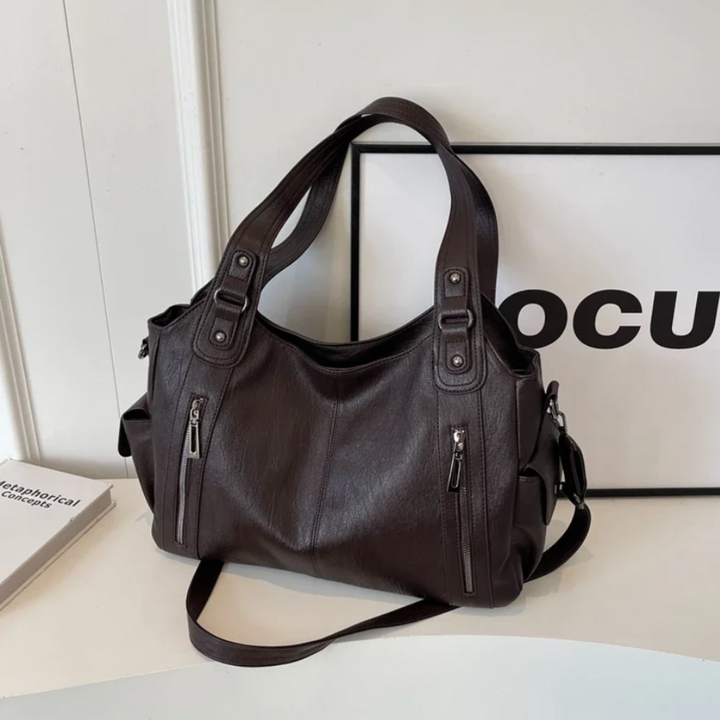 Stylish women's multi-compartment handbag with an adjustable strap; ideal for practical organization.
