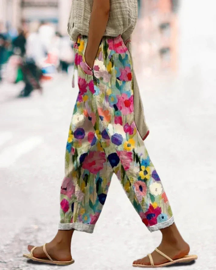 Women's multicolor floral print pants with pockets, ideal for casual spring/summer boho style. Comfortable tapered leg.