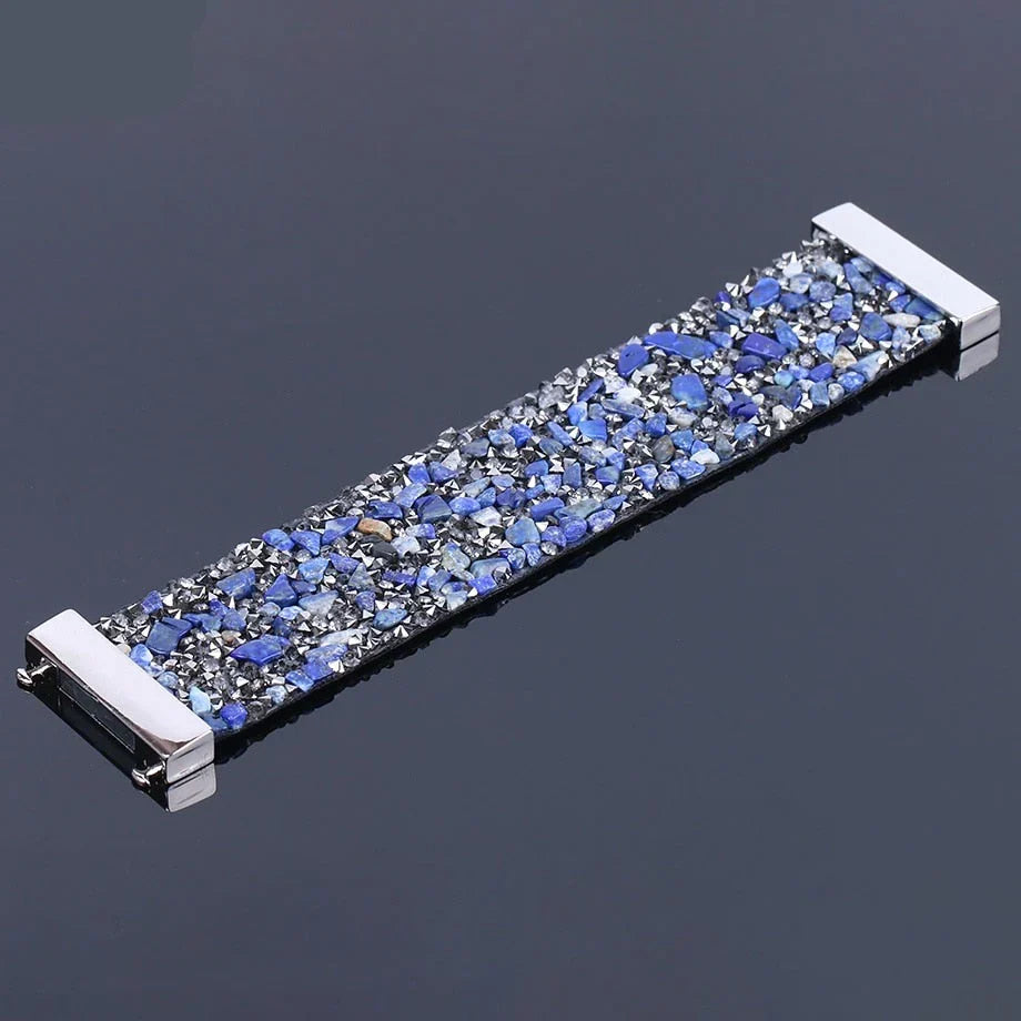 Bohemian style women's bracelet featuring natural stones, crystals, and a leather wrap.