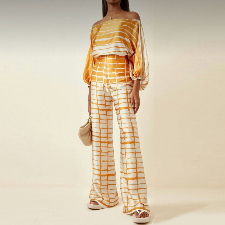 Complete women's summer off-shoulder two-piece set: patterned top and matching shorts for elegance.