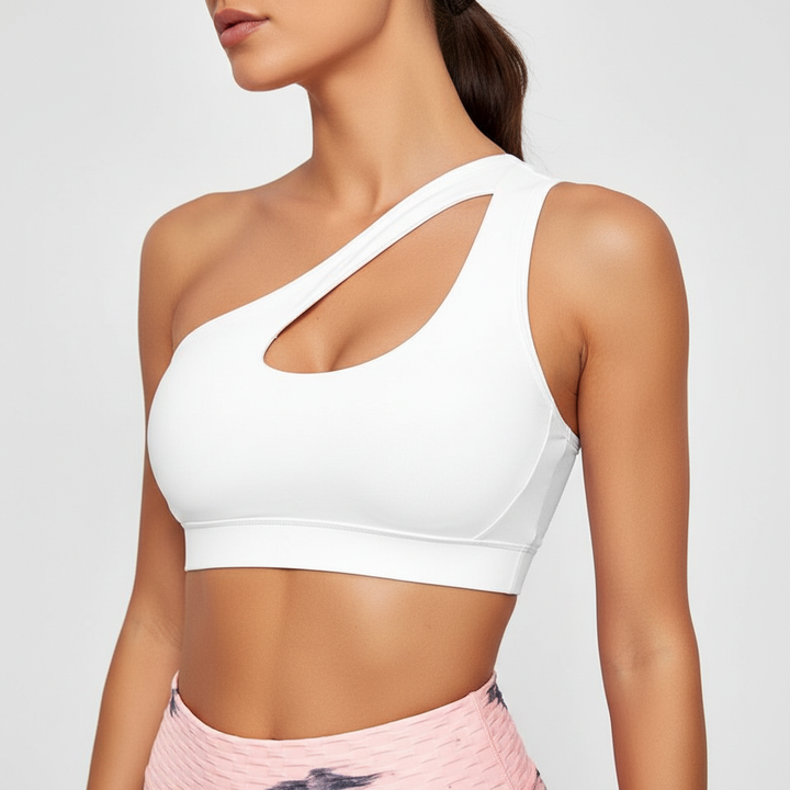 Breathable women's one-shoulder sports bra provides athletic support. Features a trendy cutout design for activewear.