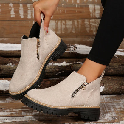 Close-up of women's functional orthopedic boots, showing zipper and durable sole.