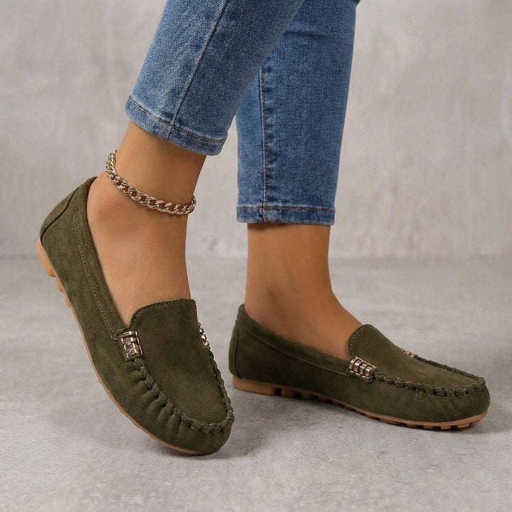 Women's driving moccasins featuring orthopedic comfort soles. Stylish slip-on loafers with a modern metallic accent.