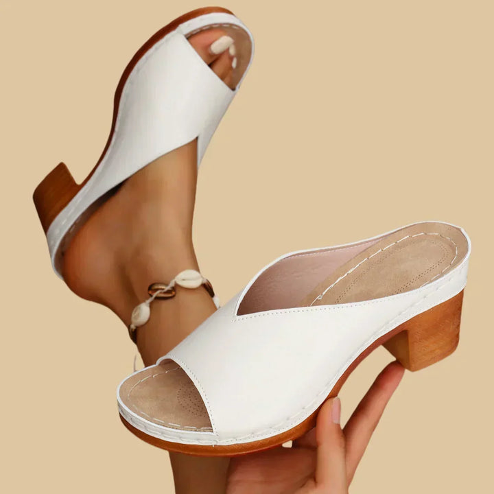 Silver women's orthopedic flat sandals, stylish & supportive footwear for versatile everyday wear.